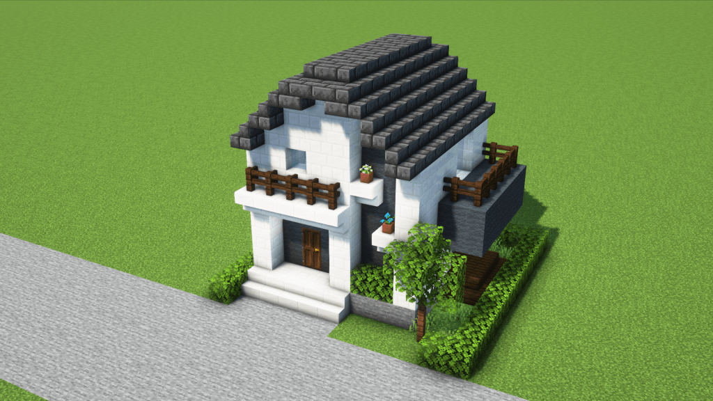 コンパクトでシンプルな建売風の白黒の家。ウッドデッキ付き