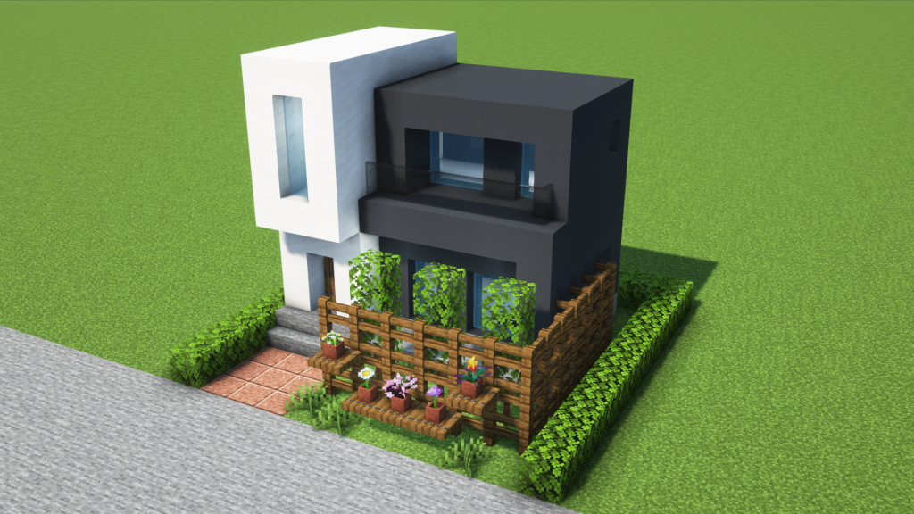 コンパクトでモダンな白黒の家。庭とフェンスにプランター付き